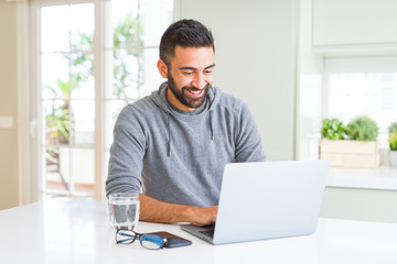 Man smiling working using computer laptop