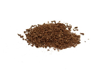 Grated chocolate. Heap of ground chocolate isolated on white background with clipping path, closeup.