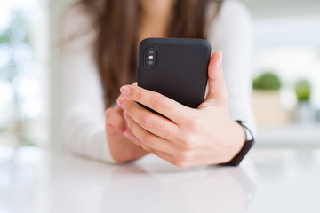 Close up of young woman using smartphone