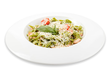 Pasta with spinach, salmon, parmesan and tomatoes. Dish isolated on white