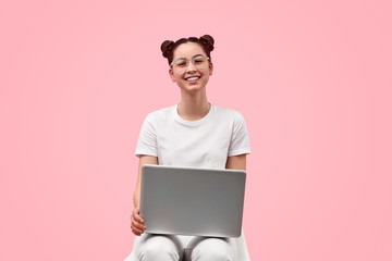Cheerful teenager using laptop