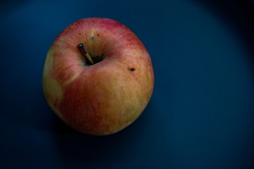 red apple on black background