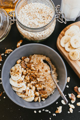 Healthy breakfast oatmeal bowl with banana and nuts