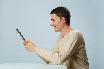 Man is using tablet computer for communication in chat or video chat. Social media concept.