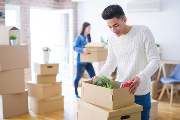 Beautiful young asian couple looking happy and smiling excited moving to a new home