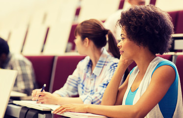 Fototapeta premium education, high school, university, learning and people concept - group of international students talking in lecture hall