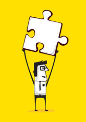 Businessman holding up a puzzle