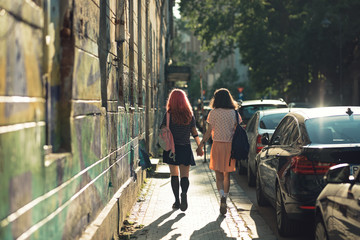 two lesbian girls, couple kiss romantically on the street in the city show love to each other gay pride LGBT pride world movement lesbian, gay, bisexual, transgender proud of their sexual orientation