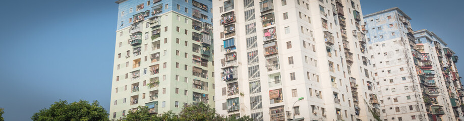 Obraz premium Panoramic lookup typical condos with hanging clothes over blue sky in Hanoi, Vietnam