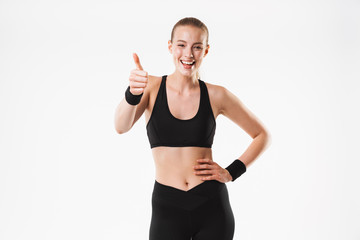 Image of caucasian beautiful woman wearing tracksuit smiling with thumb up