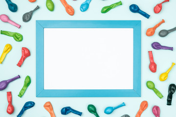 Colorful balloons and frame on colorful background top view. Birthday or party mockup