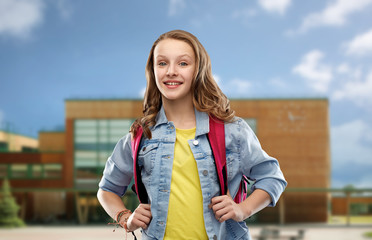 education and people concept - happy smiling teenage student girl with bag over school background