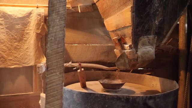 Interior of watermill. Grinding Grain into Flour at the Old Stone Mill