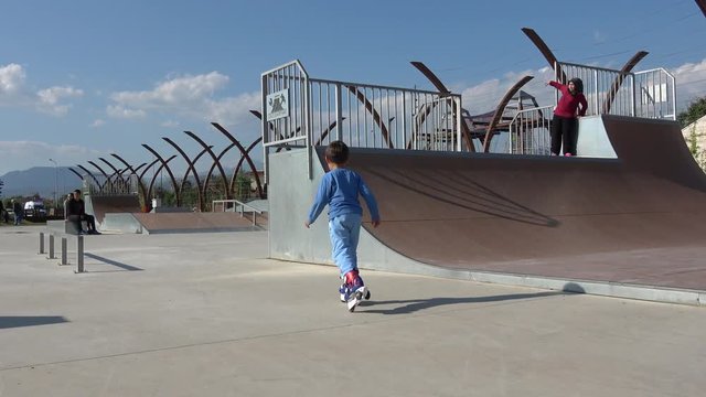 Fethi Bey Park, Fethiye, Turkey - 16th of April 2019: 4K Kid learns riding rollers at the special area