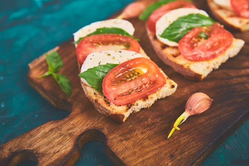 Bruschetta with tomatoes, mozzarella cheese and basil