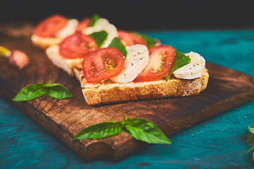 Bruschetta with tomatoes, mozzarella cheese and basil