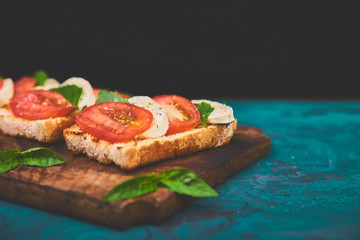 Bruschetta with tomatoes, mozzarella cheese and basil