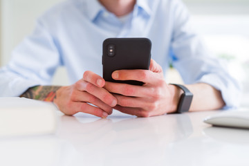 Close up of business man working using smartphone