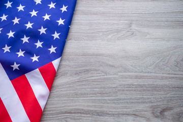 American flag on a wooden table background. Space for text