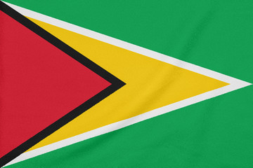 Flag of Guyana on textured fabric. Patriotic symbol