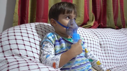 4K Child in inhaling mask coughes