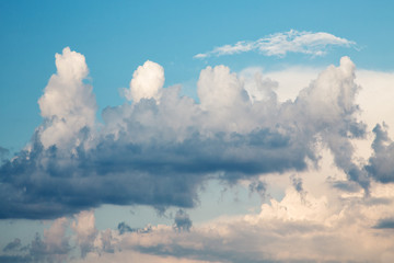 dark evening cumulus clouds in the setting sun