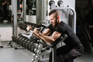 Fototapeta na wymiar Man lifting weight in the gym. Working hard