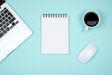 Minimal working desk with laptop and blank notepad page