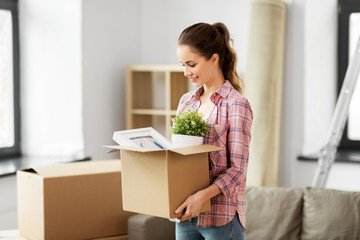 people, repair and real estate concept - smiling woman with stuff moving to new home