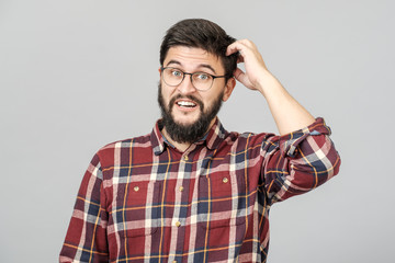 Fototapeta premium Portrait of focused smart male model with with thoughtful determined expression