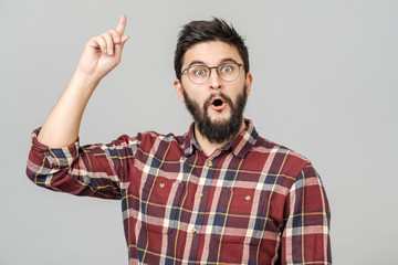 Fototapeta premium Thrilled excited guy in glasses isolated over gray