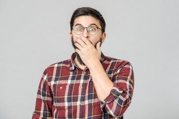Thrilled excited guy in glasses isolated over gray