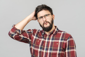 Portrait of focused smart male model with with thoughtful determined expression