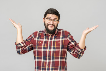 Fototapeta premium Portrait of handsome guy looking upside and shrugging his shoulders