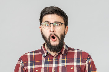 Thrilled excited guy in glasses isolated over gray