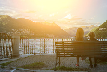 Woman and her daughter resting near the lake Como.