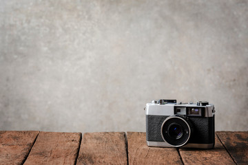 Retro camera on wooden board with copyspace