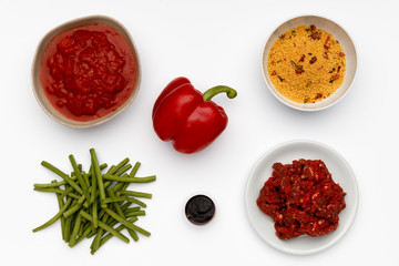 Raw ingredients for a bowl of a delicious Chipolte Meat Balls and couscous with vegetables and spices.