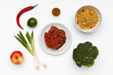 Raw ingredients for a bowl of a delicious Ras El Hanout and couscous with vegetables and spices.