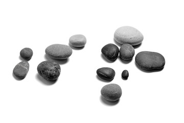 Scattered sea pebbles. Heap of smooth gray and black stones isolated on white background. Rounded rocks