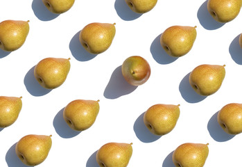 Pattern of ripe pears with a hard shadow on white background. Minimal concept. Creative background.