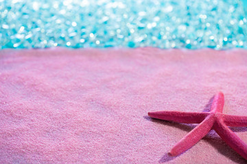 Starfish in pink sand beach and tropical sea