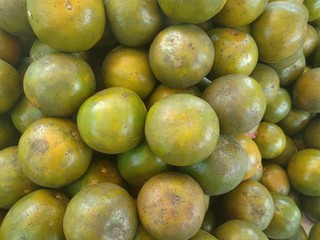 A lot of the green orange fruit in supper market, food background texture concept