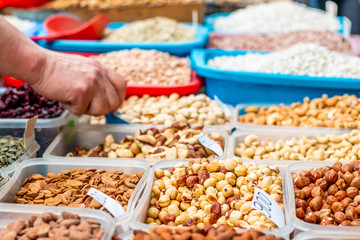 Nuts and dried fruits collection in the plastic boxes ready for sale on the marketplace in Belgrade. Close up