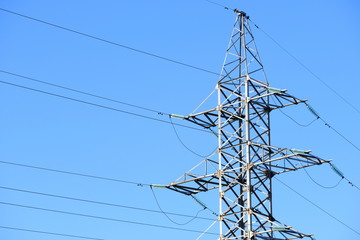 High voltage power line or tower power lines against a blue sky