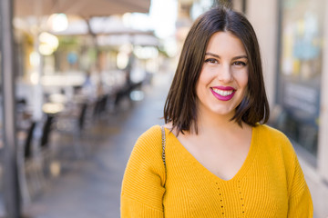 Beautiful young woman smiling cheerful walking on the street on a sunny day, casual pretty girl at the town