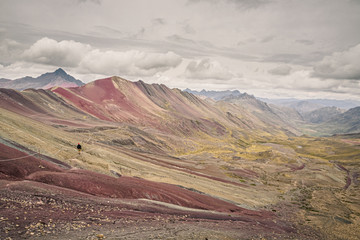 Rainbow mountain or Vinicunca in southern Peru. Man doing trekking
