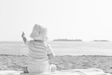 Baby Pointing to the Sky by Ocean