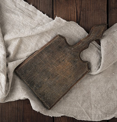 very old empty brown wooden cutting board with handle