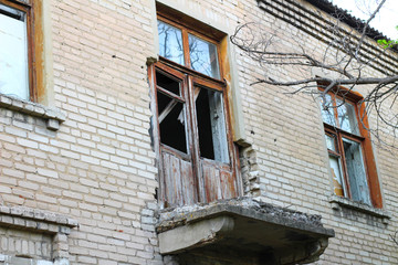 Fototapeta na wymiar smashed a shot of an old brick building balcony at the Donbass in Ukraine